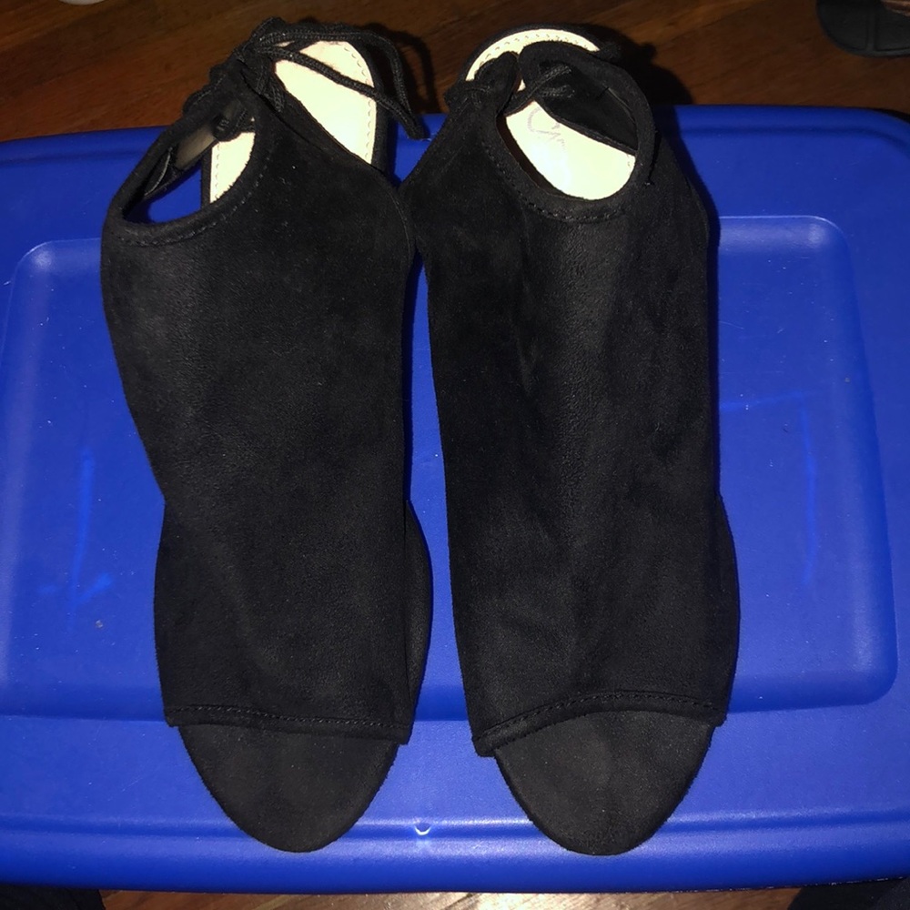 Gently worn black pumps that tie in the back